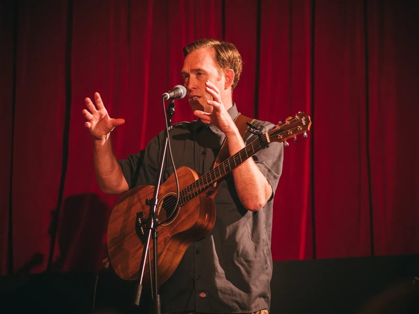 Andy spricht zum Saal, die Gitarre noch über der Schulter